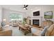 Comfortable living room with fireplace, complemented by neutral furniture and bright natural light at 9117 Meadow Mist Ct, Raleigh, NC 27617