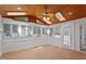 Bright sunroom featuring wood ceiling, skylights, ceiling fan, and large windows offering lots of natural light at 9117 Meadow Mist Ct, Raleigh, NC 27617