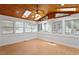 Bright sunroom featuring wood ceiling, skylights, ceiling fan, and large windows offering lots of natural light at 9117 Meadow Mist Ct, Raleigh, NC 27617