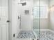 Beautiful glass enclosed shower with white tiled walls and gray tile floors at 915 Edgewater Cir, Chapel Hill, NC 27516