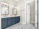 Chic bathroom with double sinks, navy vanity, and stylish hexagon-tiled floor at 915 Edgewater Cir, Chapel Hill, NC 27516
