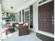 Inviting covered porch featuring cozy wicker furniture and stylish decorative accents at 915 Edgewater Cir, Chapel Hill, NC 27516