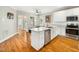 Bright kitchen with stainless steel appliances, quartz countertops, and a functional island at 915 Edgewater Cir, Chapel Hill, NC 27516