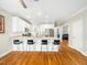 Bright and spacious kitchen with white cabinets, stainless appliances, and a large center island with bar stool seating at 915 Edgewater Cir, Chapel Hill, NC 27516