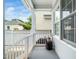 Charming porch space with a window, white railing, and a black side table with a watering can at 915 Edgewater Cir, Chapel Hill, NC 27516