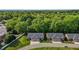 Aerial view of two brick homes surrounded by lush greenery at 928 Arrowhead Ln, Mebane, NC 27302