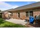 Brick home's patio with an umbrella-covered table, offering a delightful outdoor space at 928 Arrowhead Ln, Mebane, NC 27302