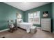 Cozy bedroom with a rocking chair, day bed, and a bright window for natural light at 928 Arrowhead Ln, Mebane, NC 27302