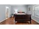 Relaxing bedroom featuring hardwood floors, a cozy bed, and a bright window at 928 Arrowhead Ln, Mebane, NC 27302