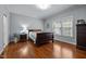 Comfortable bedroom with hardwood floors, soft natural light, and neutral wall color at 928 Arrowhead Ln, Mebane, NC 27302