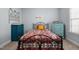 Inviting bedroom with patterned bedding, vintage furniture, and natural light from the window at 928 Arrowhead Ln, Mebane, NC 27302