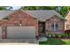 Charming brick home featuring a one-car garage, tidy lawn and inviting front porch at 928 Arrowhead Ln, Mebane, NC 27302