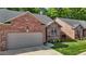 Charming brick home featuring an attached garage and beautifully landscaped front yard at 928 Arrowhead Ln, Mebane, NC 27302