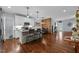 Open-concept kitchen with island seating, white cabinets, and hardwood floors at 928 Arrowhead Ln, Mebane, NC 27302