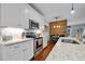 Modern kitchen featuring white cabinets, stainless steel appliances, and granite countertops at 928 Arrowhead Ln, Mebane, NC 27302