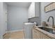 Well-lit laundry room featuring modern appliances, granite countertops, and ample storage at 928 Arrowhead Ln, Mebane, NC 27302