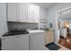 Bright laundry room with washer, dryer, granite countertop, and storage cabinets above at 928 Arrowhead Ln, Mebane, NC 27302