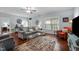 Spacious living room featuring hardwood floors, comfortable seating, and abundant natural light at 928 Arrowhead Ln, Mebane, NC 27302