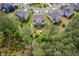 Expansive aerial view captures lush backyard with brick fire pit, and neighboring properties showcasing the community's layout at 948 Uprock Dr, Cary, NC 27519