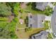 Expansive aerial view captures the well-manicured lawn with brick fire pit, garden and surrounding landscape at 948 Uprock Dr, Cary, NC 27519