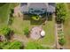 Backyard aerial view highlighting brick fire pit, garden, and lush green spaces for the perfect outdoor living at 948 Uprock Dr, Cary, NC 27519