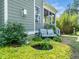 Back patio features a cozy seating area, tranquil water feature, and lush garden for relaxing outdoor living at 948 Uprock Dr, Cary, NC 27519