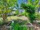 Landscaped backyard features a beautiful garden archway with lush greenery and tranquil outdoor living spaces at 948 Uprock Dr, Cary, NC 27519
