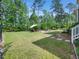 Lush backyard featuring a stone path, patio and lounge area at 948 Uprock Dr, Cary, NC 27519