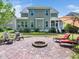 Backyard brick fire pit and lounge chairs with large lawn and screened in porch perfect for relaxation and entertainment at 948 Uprock Dr, Cary, NC 27519