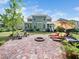 Inviting backyard with brick fire pit, lounge chairs, and manicured lawn provides perfect outdoor entertainment space at 948 Uprock Dr, Cary, NC 27519