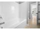 Bright bathroom featuring a shower/tub combo with white tiled walls at 948 Uprock Dr, Cary, NC 27519