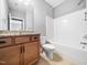 Bathroom with wooden cabinets, granite countertops, shower/tub, and tile floors at 948 Uprock Dr, Cary, NC 27519