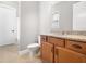 Bright bathroom features a granite vanity and commode with neutral wall color and tiled floor at 948 Uprock Dr, Cary, NC 27519