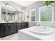 Bathroom features a soaking tub, double vanity, and a frosted glass window at 948 Uprock Dr, Cary, NC 27519