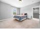 Bright bedroom features a light color scheme, large window, and neutral carpet at 948 Uprock Dr, Cary, NC 27519