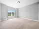 Spacious carpeted bedroom with natural light shining through the large window at 948 Uprock Dr, Cary, NC 27519