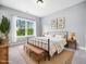 Cozy bedroom with large window, natural light, and earth tone decor elements at 948 Uprock Dr, Cary, NC 27519