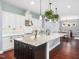 Bright kitchen featuring a large island, granite countertops, and modern white cabinets at 948 Uprock Dr, Cary, NC 27519