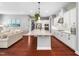 Open concept kitchen with an expansive island, stainless steel appliances, and hardwood floors at 948 Uprock Dr, Cary, NC 27519
