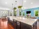 Stylish kitchen island with a granite countertop, dark wood cabinets, and a farmhouse sink at 948 Uprock Dr, Cary, NC 27519