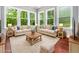 Comfortable living room with plush sofas, a wooden coffee table, and natural light from the windows at 948 Uprock Dr, Cary, NC 27519