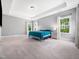 Spacious main bedroom with tray ceilings and large windows that bring in natural light at 948 Uprock Dr, Cary, NC 27519