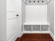 Mudroom has white beadboard and a bench with storage cubbies and hooks for organization at 948 Uprock Dr, Cary, NC 27519