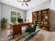 Well-appointed office with a wooden desk, stylish chair, and built-in bookshelves for a professional atmosphere at 948 Uprock Dr, Cary, NC 27519