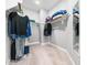Walk-in closet with carpeted floor has shelves and rods on multiple walls for maximum storage at 948 Uprock Dr, Cary, NC 27519