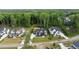 An aerial view of three upscale homes on expansive green lots surrounded by lush trees at 949 Harrison Ridge Rd, Wake Forest, NC 27587