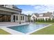 This backyard offers a built-in grill, refreshing pool with fountains, and patio for relaxation and entertainment at 949 Harrison Ridge Rd, Wake Forest, NC 27587