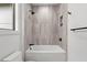 Close up of a bathtub shower combination with modern fixtures in a stylish bathroom at 949 Harrison Ridge Rd, Wake Forest, NC 27587