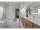 Luxurious bathroom featuring a soaking tub, a double vanity, and elegant lighting at 949 Harrison Ridge Rd, Wake Forest, NC 27587