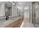 Modern bathroom with double sink vanity, stone countertops, and a sleek walk-in shower with glass door at 949 Harrison Ridge Rd, Wake Forest, NC 27587